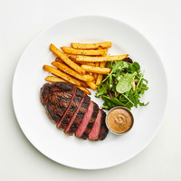 Grilled pepper sirloin steak - braised black cabbage - baby carrots - red wine jus